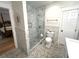 Stylish bathroom featuring a modern glass-enclosed shower, toilet and vanity with elegant mosaic tile flooring at 4002 Wieuca Ne Rd, Atlanta, GA 30342