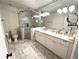 Bathroom featuring a walk-in shower, a double sink vanity, and marble floors at 4002 Wieuca Ne Rd, Atlanta, GA 30342