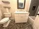 Modern bathroom featuring a pedestal sink, toilet, pebble-style tile floor, and tiled shower at 4002 Wieuca Ne Rd, Atlanta, GA 30342