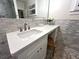 Bright bathroom vanity features white marble countertop, with decorative sink, white cabinetry, and tiled walls at 4002 Wieuca Ne Rd, Atlanta, GA 30342