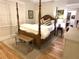 Cozy bedroom with a four-poster bed, soft lighting, and hardwood floors creating a warm, relaxing atmosphere at 4002 Wieuca Ne Rd, Atlanta, GA 30342
