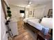 Inviting bedroom with natural light, ceiling fan, and wood floors complemented by a four-poster bed and TV at 4002 Wieuca Ne Rd, Atlanta, GA 30342
