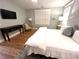 Bedroom with wood floors, cool wall color, plantation shutters, and dark wood dresser at 4002 Wieuca Ne Rd, Atlanta, GA 30342