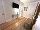 Bedroom with hardwood floors, plantation shutters, TV and a decorative table between the door and bed at 4002 Wieuca Ne Rd, Atlanta, GA 30342
