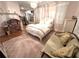 Comfortable bedroom featuring a bed, sofa, dollhouse, and pink rug at 4002 Wieuca Ne Rd, Atlanta, GA 30342