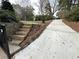 Long driveway with stone steps leading up to a landscaped area, creating a welcoming approach to the property at 4002 Wieuca Ne Rd, Atlanta, GA 30342