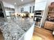 Island kitchen with stainless appliances, granite countertops, wood floors and white cabinets at 4002 Wieuca Ne Rd, Atlanta, GA 30342