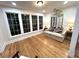 Sun-filled sitting room with a large window, couch, wood floors, and a decorative mirror at 4002 Wieuca Ne Rd, Atlanta, GA 30342