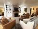 Inviting living room with a brick fireplace, built-in shelving, comfortable seating, and hardwood floors at 4002 Wieuca Ne Rd, Atlanta, GA 30342