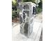 Close up of mailbox showing address numbers on a stone column with a sidewalk and foliage in the background at 4002 Wieuca Ne Rd, Atlanta, GA 30342