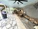 Large covered patio with flagstone flooring and ceiling fans, perfect for outdoor gatherings at 4002 Wieuca Ne Rd, Atlanta, GA 30342