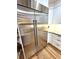Spacious stainless steel refrigerator adding style and utility to the kitchen with ample storage and adjacent white cabinetry at 4002 Wieuca Ne Rd, Atlanta, GA 30342