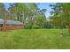 Lush, green backyard providing ample space for recreation, complemented by mature trees and landscaping at 5630 Lake Forrest Dr, Sandy Springs, GA 30342