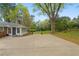 Large backyard with a spacious patio perfect for entertaining, surrounded by mature trees at 5630 Lake Forrest Dr, Sandy Springs, GA 30342