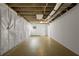 Unfinished basement featuring exposed beams and newly painted walls, awaiting your personal touch at 5630 Lake Forrest Dr, Sandy Springs, GA 30342