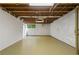 Unfinished basement featuring painted floors, white walls, and natural light from a window at 5630 Lake Forrest Dr, Sandy Springs, GA 30342