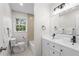 Bathroom with double vanity, modern fixtures, white cabinets, and shower at 5630 Lake Forrest Dr, Sandy Springs, GA 30342