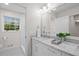Beautiful bathroom featuring a marble countertop, patterned tile floor, and bright window at 5630 Lake Forrest Dr, Sandy Springs, GA 30342