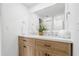 Bright bathroom featuring a double sink vanity, modern mirror, and stylish decor at 5630 Lake Forrest Dr, Sandy Springs, GA 30342