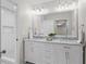 Bathroom with a double sink vanity, marble countertop, and bright finishes at 5630 Lake Forrest Dr, Sandy Springs, GA 30342