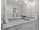 Bright bathroom with double sinks, marble countertops, and a large mirror at 5630 Lake Forrest Dr, Sandy Springs, GA 30342