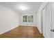 This bedroom has hardwood floors, a window with green views and ample closet space at 5630 Lake Forrest Dr, Sandy Springs, GA 30342