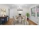 This dining room features hardwood floors, a chandelier, and a round table with four chairs at 5630 Lake Forrest Dr, Sandy Springs, GA 30342