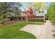 Charming single-story brick home with a well-manicured lawn, mature trees, and a paved driveway at 5630 Lake Forrest Dr, Sandy Springs, GA 30342