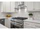 This kitchen features stainless steel appliances, white subway tile and white cabinets at 5630 Lake Forrest Dr, Sandy Springs, GA 30342