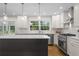 This kitchen features white cabinets, stainless steel appliances and a center island at 5630 Lake Forrest Dr, Sandy Springs, GA 30342