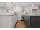 Modern kitchen featuring stainless steel appliances, custom cabinets, and a center island at 5630 Lake Forrest Dr, Sandy Springs, GA 30342