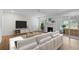 Bright living room features white brick fireplace, hardwood floors, and large white couch at 5630 Lake Forrest Dr, Sandy Springs, GA 30342