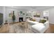 Cozy living room with white brick fireplace, hardwood floors, neutral paint and large white couch at 5630 Lake Forrest Dr, Sandy Springs, GA 30342