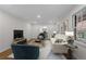 Bright living room features hardwood floors, neutral paint, and lots of natural light from the large windows at 5630 Lake Forrest Dr, Sandy Springs, GA 30342