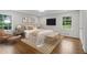 Bright main bedroom featuring hardwood floors, fresh paint, and natural light from two windows at 5630 Lake Forrest Dr, Sandy Springs, GA 30342