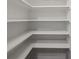 Bright pantry features open shelving with a clean, bright white color at 5630 Lake Forrest Dr, Sandy Springs, GA 30342