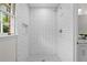 Newly renovated shower with white subway tile, black mosaic floor, and updated fixtures at 5630 Lake Forrest Dr, Sandy Springs, GA 30342
