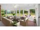 Cozy sunroom with large windows, comfortable seating, and views of the landscaped backyard at 5630 Lake Forrest Dr, Sandy Springs, GA 30342
