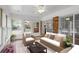 Inviting sunroom with wicker furniture, bright windows, and a comfortable seating area at 5630 Lake Forrest Dr, Sandy Springs, GA 30342
