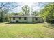 A home with a spacious green backyard with an air conditioner and trees at 794 Casplan St, Atlanta, GA 30310