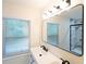 Modern bathroom with double vanity, large mirror, and updated shower at 794 Casplan St, Atlanta, GA 30310