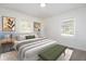 Bright bedroom with neutral colors, two windows, carpet, and bench at 794 Casplan St, Atlanta, GA 30310