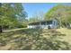 Charming single-story home featuring a large front yard with mature trees at 794 Casplan St, Atlanta, GA 30310