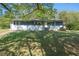 Exterior of home surrounded by a green lawn and trees, inviting curb appeal at 794 Casplan St, Atlanta, GA 30310