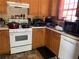 Functional kitchen with oak cabinets, white appliances, and tile flooring at 109 Millwheel Dr, Villa Rica, GA 30180