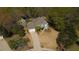 Aerial view of a suburban home featuring a manicured front lawn, driveway, and attached garage at 1165 Lea Dr, Roswell, GA 30076