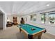 Finished basement with a pool table and a view of the swimming pool at 1165 Lea Dr, Roswell, GA 30076