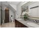 Bathroom featuring a granite countertop, large mirror, and a walk-in shower at 1165 Lea Dr, Roswell, GA 30076