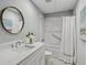 Bright bathroom featuring modern vanity, white tile, and shower with glass doors at 1165 Lea Dr, Roswell, GA 30076