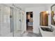 Bathroom featuring a walk-in shower, marble tile, and a closet at 1165 Lea Dr, Roswell, GA 30076